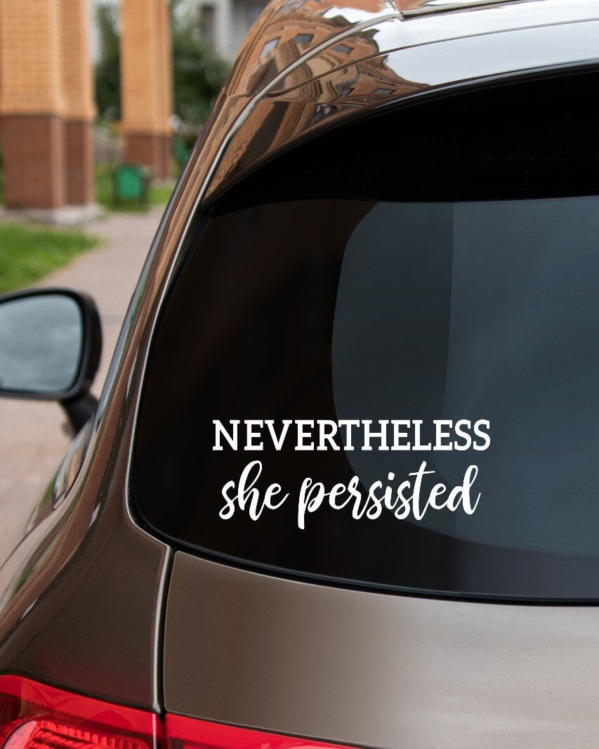 Rear car window with nevertheless she persisted Elizabeth Warren sticker