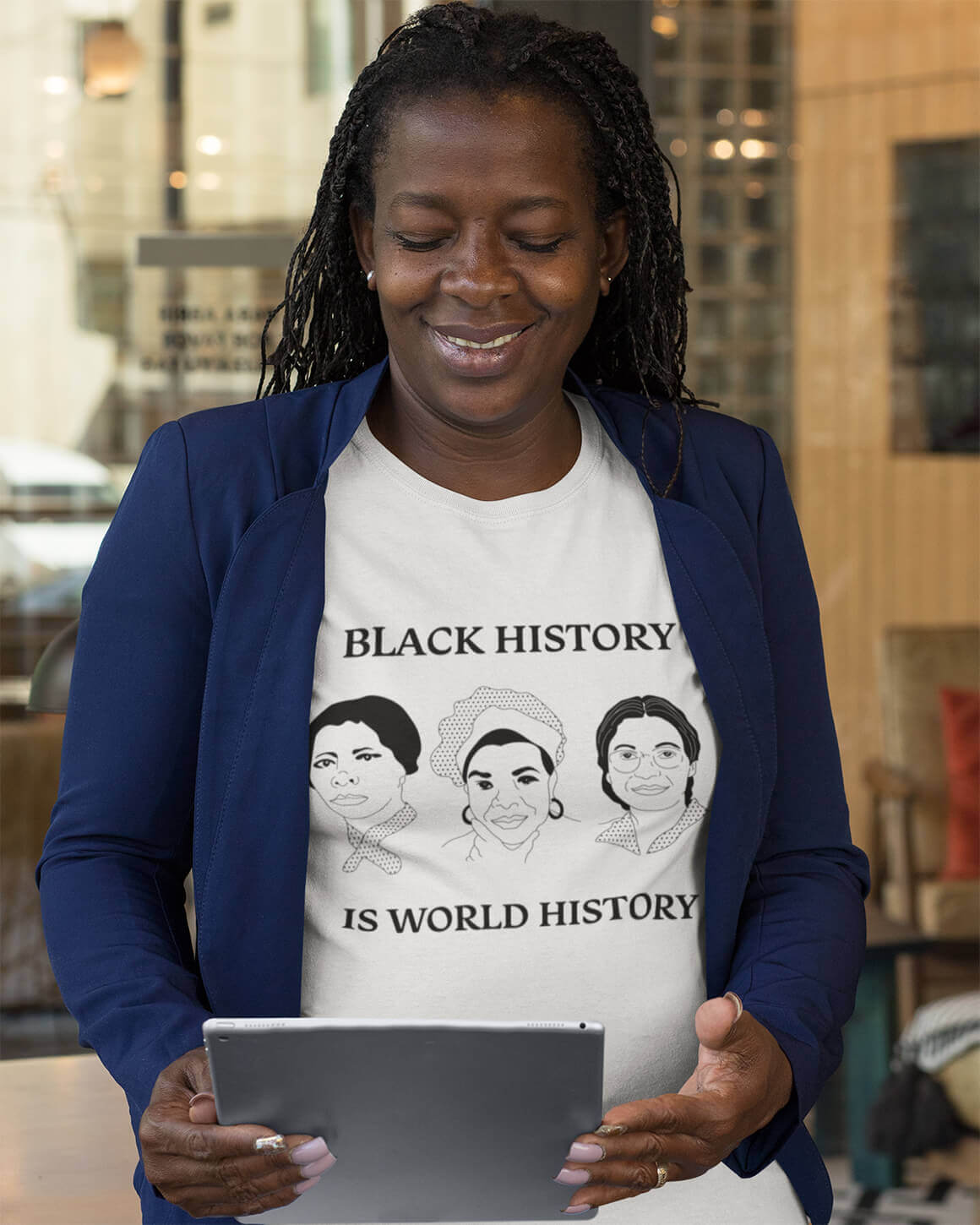 Professional woman in feminist t-shirt depicting Maya Angelou, Harriet Tubman, and Rosa Parks