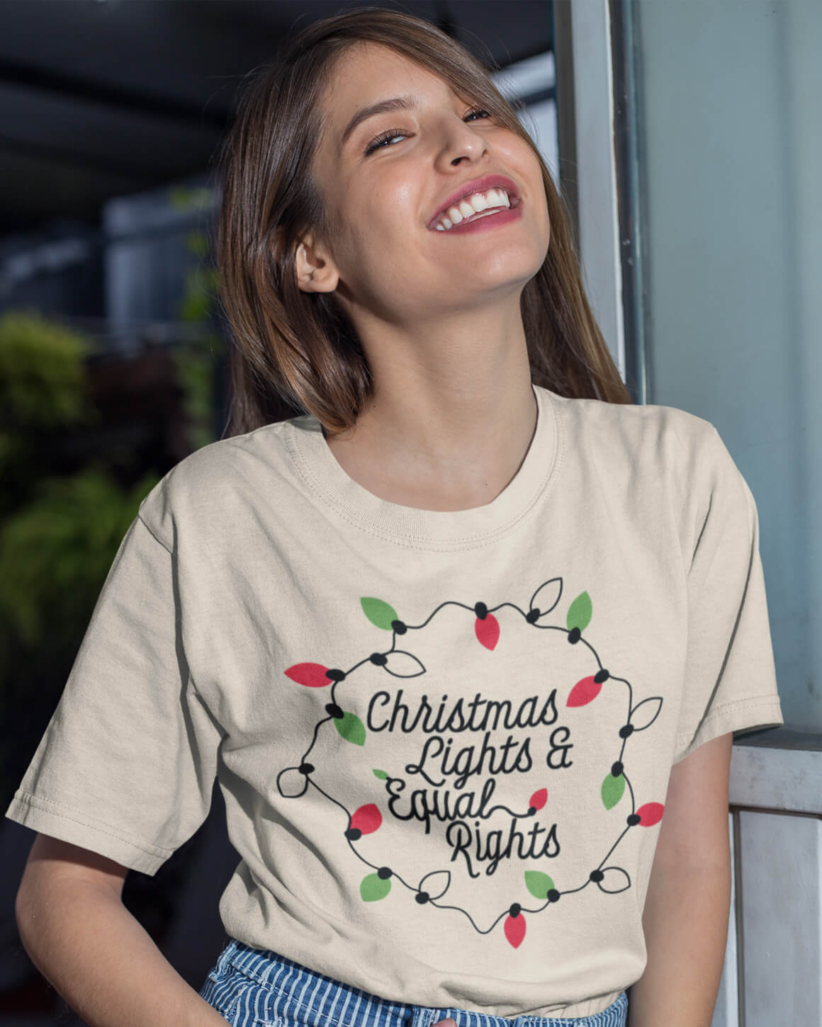 girl smiling in christmas lights and equal rights feminist christmas shirt
