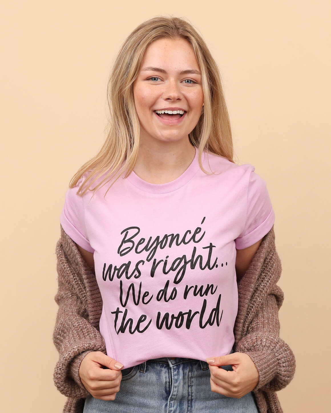 Smiling young woman wearing a pink feminist t-shirt