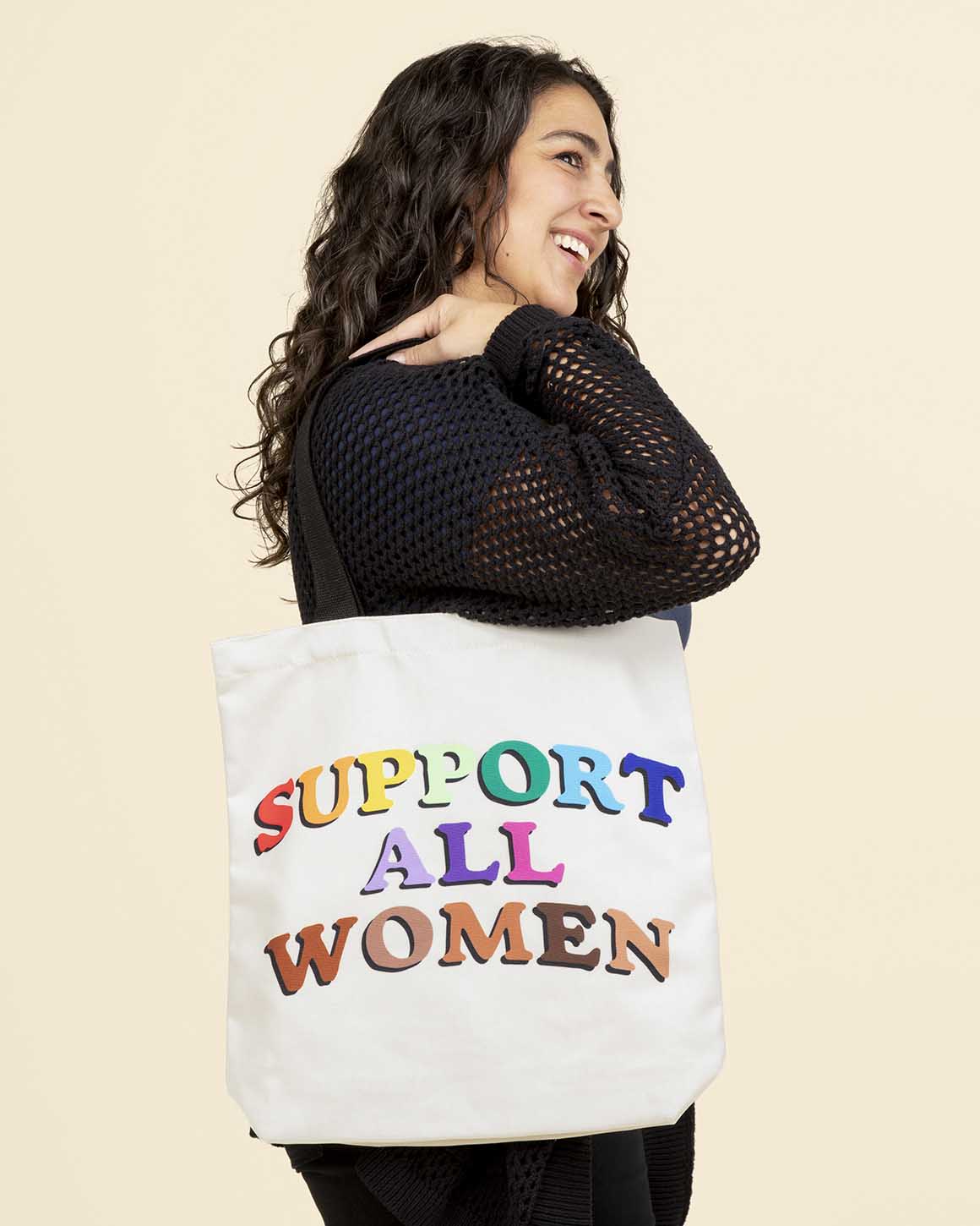 Intersectional feminist tote bag that reads support all women in rainbow lettering